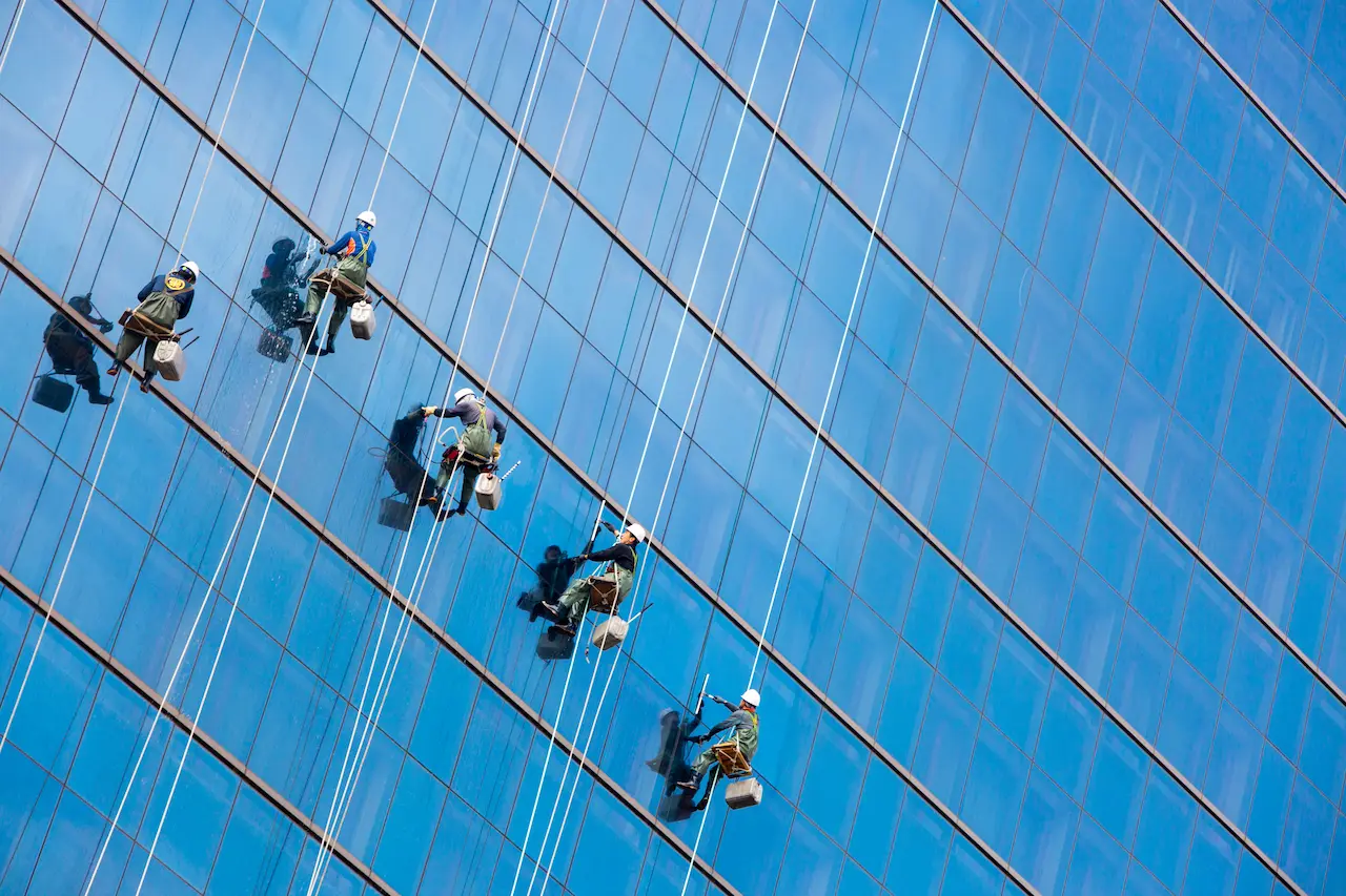 High-rise window cleaning in Florida — professional rope access technicians cleaning skyscraper windows